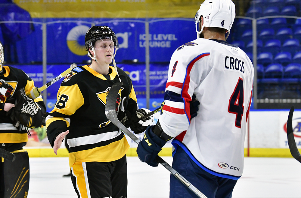 Penguins player on the ice against his competitor.