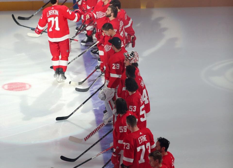 Detroit Red Wings center Dylan Larkin (71) high-fives teammates after being introduced before the season opener against the Tampa Bay Lightning at Little Caesars Arena Thursday, Oct. 14, 2021.