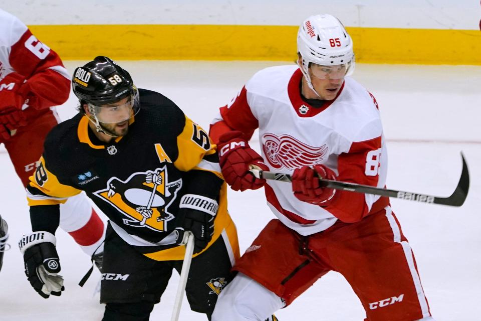 The Penguins' Kris Letang and Red Wings forward Elmer Soderblom vie for position during the first period of the preseason game on Tuesday, Sept. 27, 2022, in Pittsburgh.