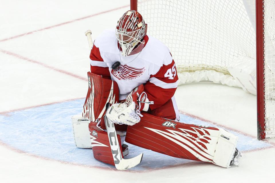 Red Wings goaltender Magnus Hellberg makes a save against the New Jersey Devils during the third period of the Wings' 5-3 win over the Devils on Friday, April 29, 2022, in Newark, New Jersey.