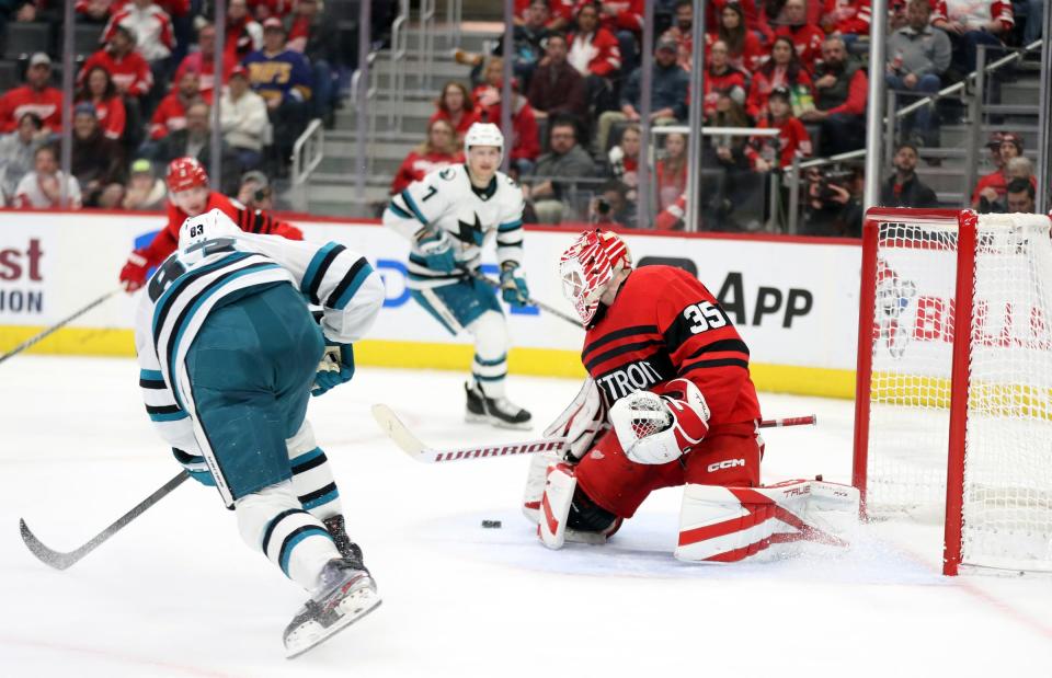 Red Wings goaltender Ville Husso makes a save against Sharks left wing Matt Nieto during the second period on Tuesday, Jan. 24, 2023, at Little Caesars Arena.