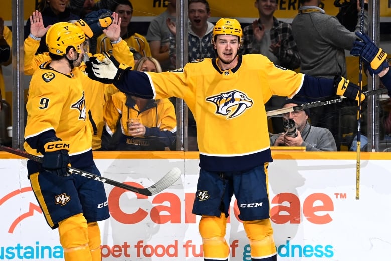 Nashville Predators centre Cody Glass, right, reaches out to celebrate with left wing Filip Forsberg after Glass scored a goal against the Winnipeg Jets.