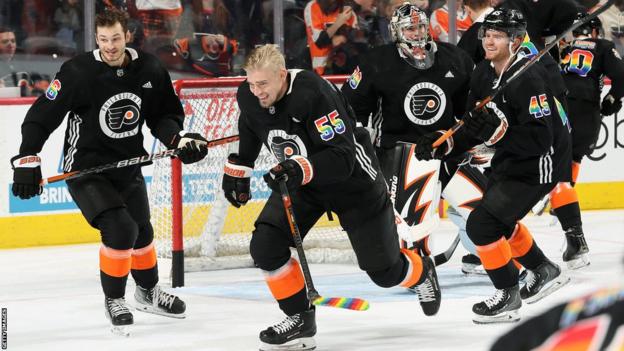 Philadelphia Flyers players wearing Pride-themed warm-jerseys