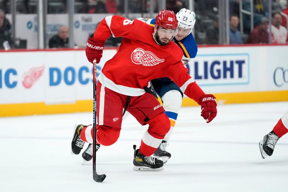 Red Wings defenseman Jake Walman protects the puck from Blues left wing Sammy Blais in the first period on Thursday, March 23, 2023, at Little Caesars Arena.