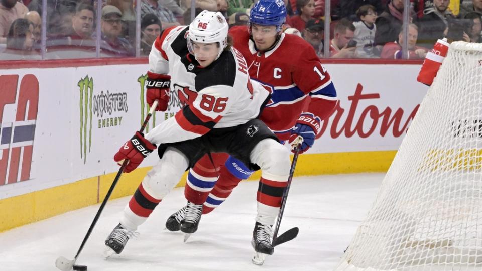 Mar 11, 2023; Montreal, Quebec, CAN; New Jersey Devils forward Jack Hughes (86) plays the puck and Montreal Canadiens forward Nick Suzuki (14) defends during the first period at the Bell Centre.