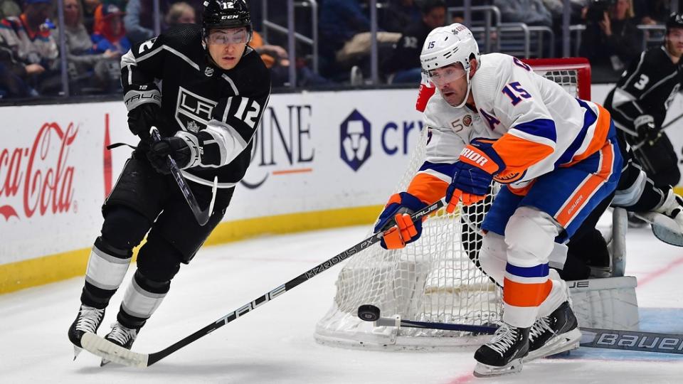 Mar 14, 2023; Los Angeles, California, USA; New York Islanders right wing Cal Clutterbuck (15) plays for the puck against Los Angeles Kings left wing Trevor Moore (12) during the first period at Crypto.com Arena.