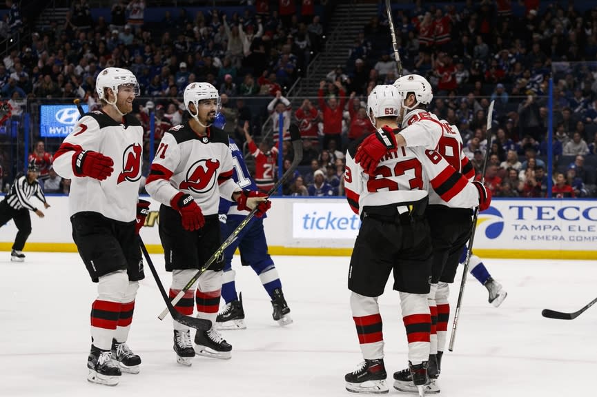 New Jersey Devils defenseman Dougie Hamilton (7), defenseman Jonas Siegenthaler (71), center Jack Hughes (86), and left wing Jesper Brett (63) celebrate goal against Tampa Bay Lightning during the second period at Amalie Arena.