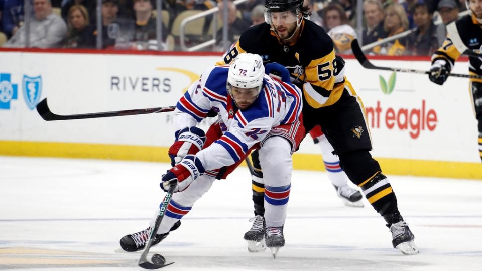 Mar 12, 2023; Pittsburgh, Pennsylvania, USA; New York Rangers center Filip Chytil (72) moves the puck against pressure from Pittsburgh Penguins defenseman Kris Letang (58) during the second period at PPG Paints Arena. Mandatory Credit: Charles LeClaire-USA TODAY Sports