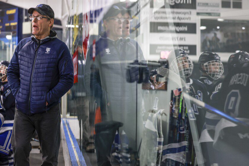 man coaches ice hockey