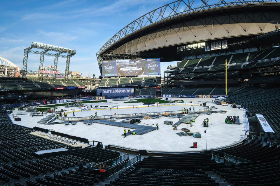 Construction of the rink for the New Year's Day NHL hockey Winter Classic between the Seattle Kraken and the Vegas Golden Knights continues Thursday, Dec. 21, 2023, in Seattle at T-Mobile Park, home of the Seattle Mariners. (Dean Rutz/The Seattle Times via AP)