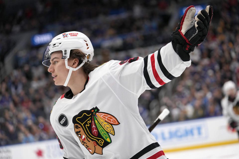 Chicago Blackhawks' Connor Bedard celebrates after scoring during the first period of an NHL hockey game against the St. Louis Blues Saturday, Dec. 23, 2023, in St. Louis. (AP Photo/Jeff Roberson)