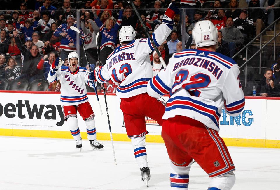 NEWARK, NEW JERSEY - FEBRUARY 22: Erik Gustafsson #56 reacts with Alexis Lafreniere #13 of the New York Rangers after Lafreniere's goal scored during the first period against the New Jersey Devils at Prudential Center on February 22, 2024 in Newark, New Jersey.