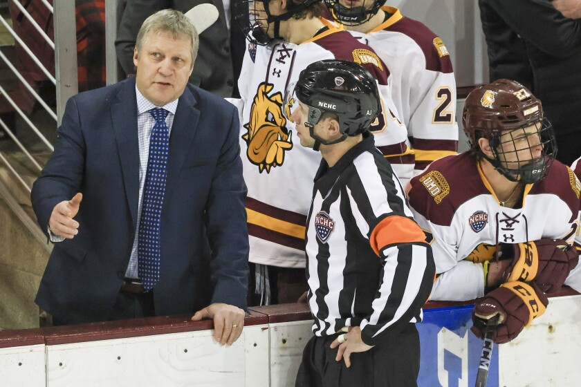 college men play ice hockey