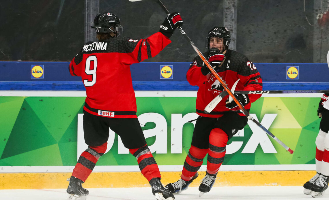 Canada thumps Swiss to top Group B