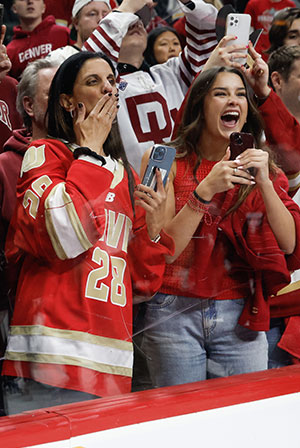 Miri Buium (left) reacts to watching her sons with the national championship trophy. (photo: Rich Gagnon)