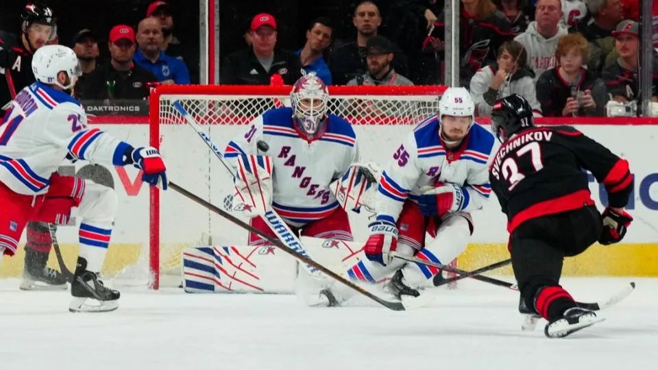 May 11, 2024; Raleigh, North Carolina, USA; Carolina Hurricanes right wing Andrei Svechnikov (37) shoots the puck against New York Rangers defenseman Ryan Lindgren (55) and goaltender Igor Shesterkin (31) during the second period in game four of the second round of the 2024 Stanley Cup Playoffs at PNC Arena.