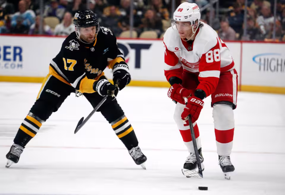 Apr 11, 2024; Pittsburgh, Pennsylvania, USA; Detroit Red Wings right wing Patrick Kane (88) skates with the puck against Pittsburgh Penguins right wing Bryan Rust (17) during the second period at PPG Paints Arena.<p>Mandatory Credit&colon; Charles LeClaire-Imagn Images </p>