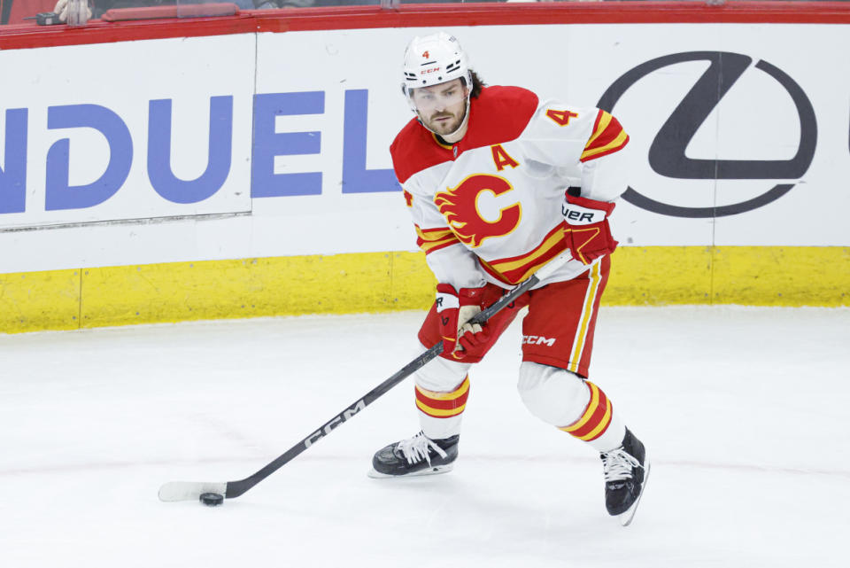 Jan 13, 2025; Chicago, Illinois, USA; Calgary Flames defenseman Rasmus Andersson (4) looks to pass the puck against the Chicago Blackhawks during the second period at United Center. Mandatory Credit: Kamil Krzaczynski-Imagn Images
