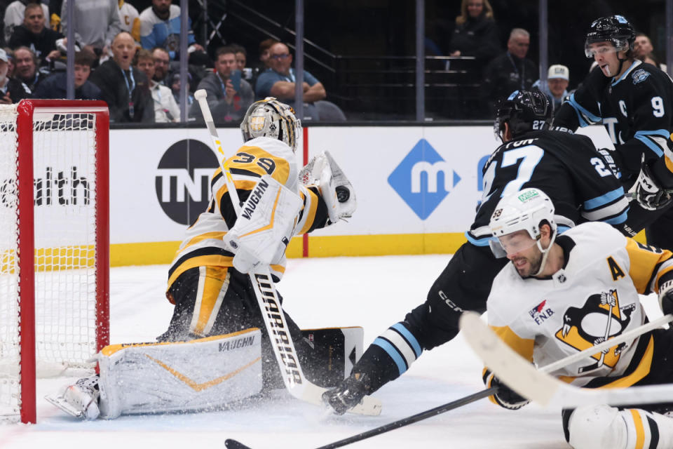 Jan 29, 2025; Salt Lake City, Utah, USA; Pittsburgh Penguins goaltender Alex Nedeljkovic (39) makes a glove save against the Utah Hockey Club during overtime at Delta Center. Mandatory Credit: Rob Gray-Imagn Images