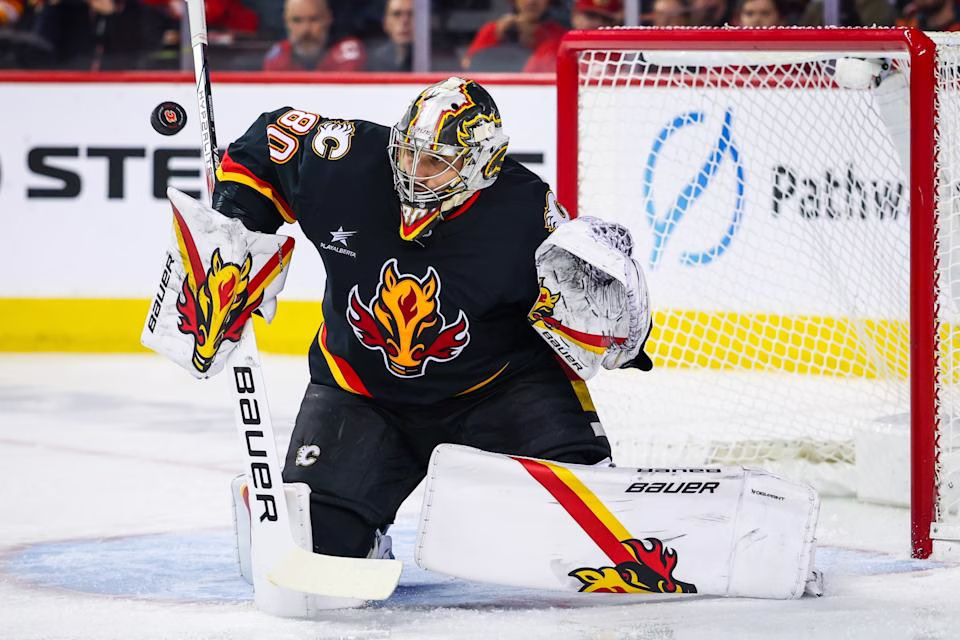 Jan 2, 2025; Calgary, Alberta, CAN; Calgary Flames goaltender Dan Vladar (80) makes a save against the Utah Hockey Club during the second period at Scotiabank Saddledome. Mandatory Credit: Sergei Belski-Imagn Images
