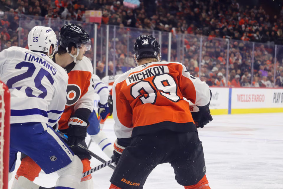 Philadelphia Flyers forward Matvei Michkov (39) and defenseman Jamie Drysdale (9) stand net-front with Tornto Maple Leafs defenseman Conor Timmins (25) at the Wells Fargo Center on Jan. 7, 2025.<p>Megan DeRuchie-The Hockey News</p>
